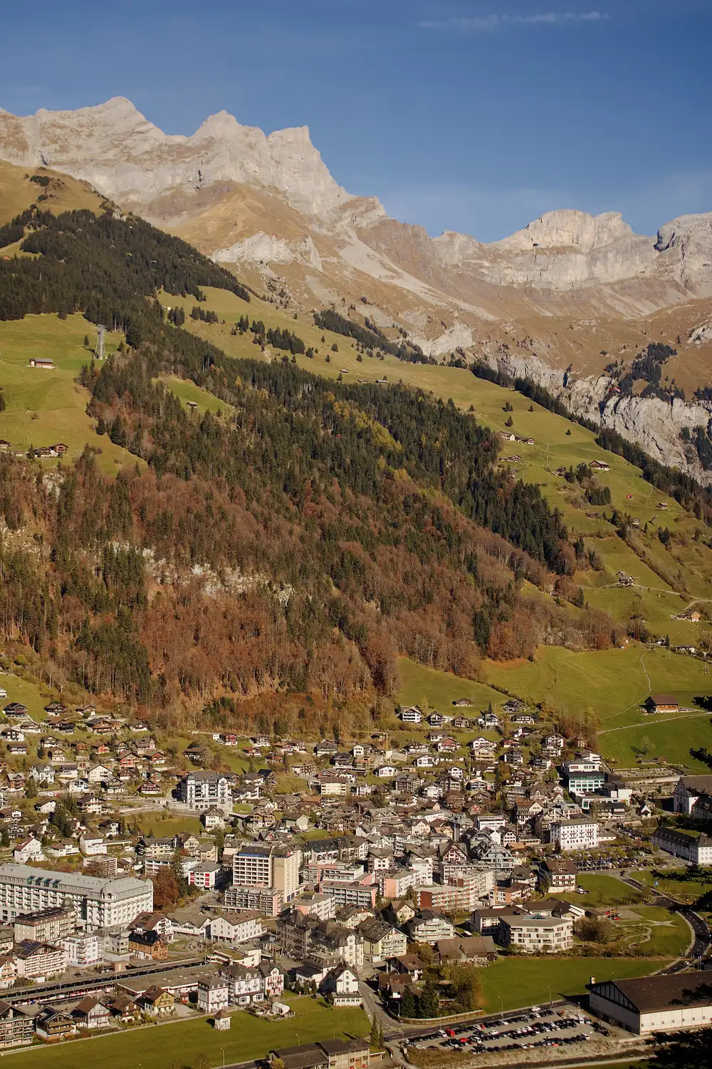 A green alpine valley and village below Swiss peaks