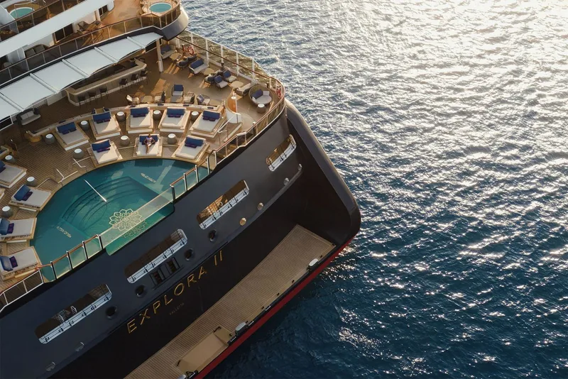 Explora II from above, wake trailing behind her in open ocean