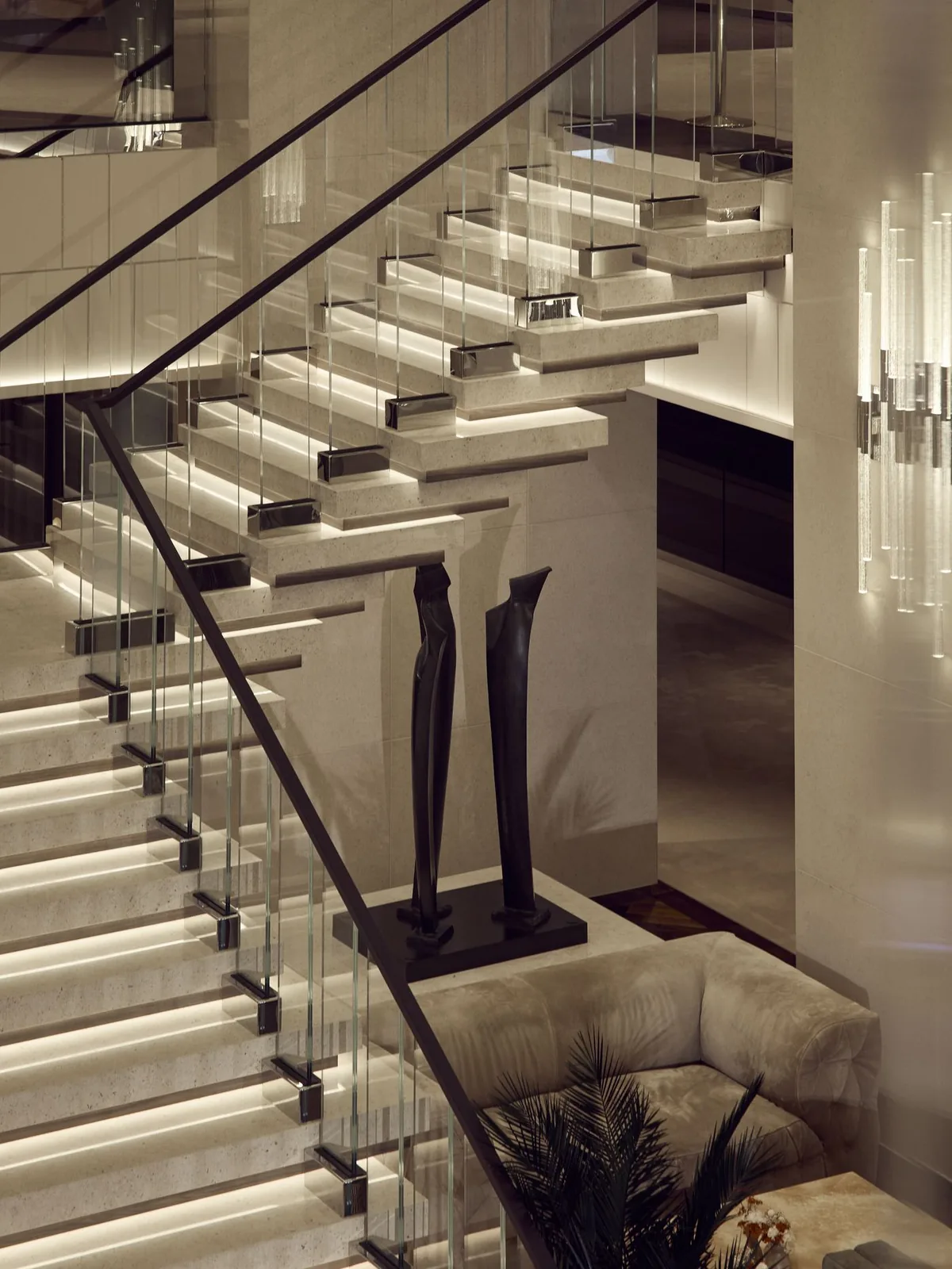 A double height lobby with a sculptural staircase curving between two decks