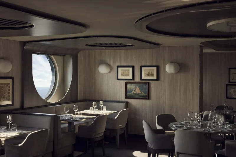 The Med Yacht Club on deck, striped loungers and a bar open to the sea