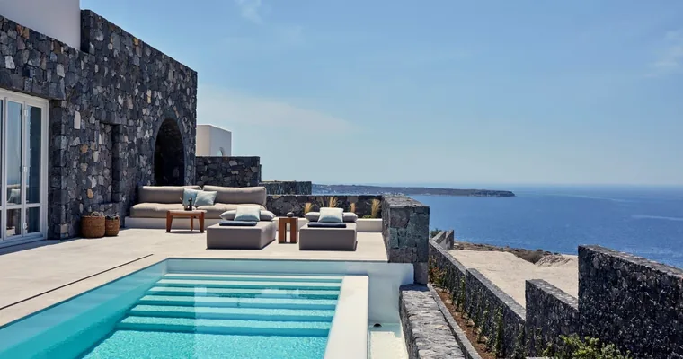 The long rooftop pool at Canaves Epitome above the Santorini caldera at dusk