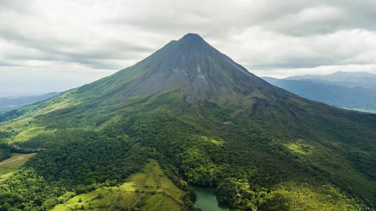 Arenal Volcano rising above green rainforest near La Fortuna, Costa Rica