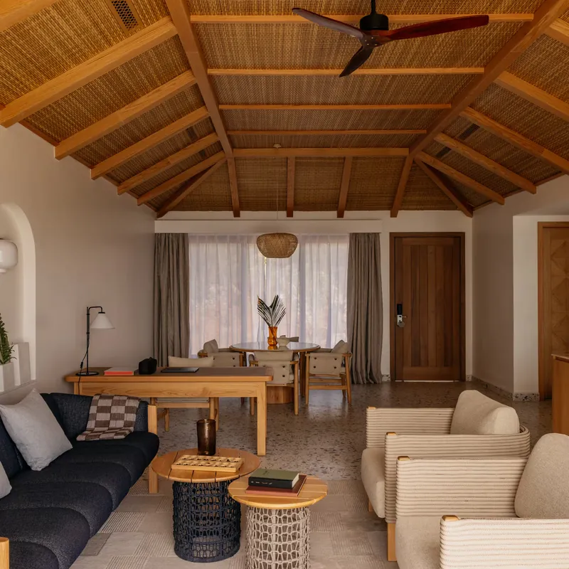 The villa lounge and dining area under a high woven ceiling