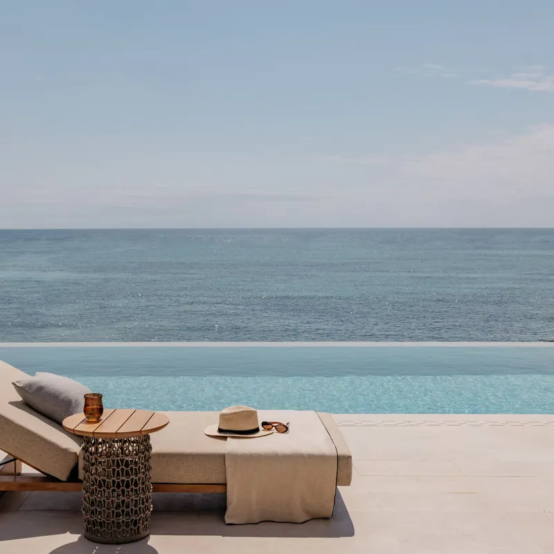 A lounger beside the villa’s private infinity pool, looking out to the Indian Ocean