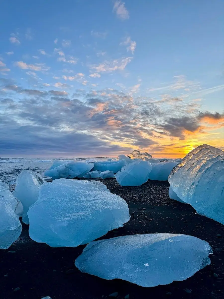 Diamond Beach Iceland · glacial icebergs on black sand at sunset