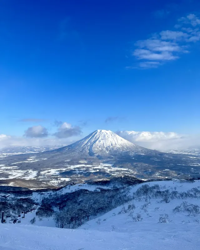 Snow covered Mount Yotei in Hokkaido under a blue sky