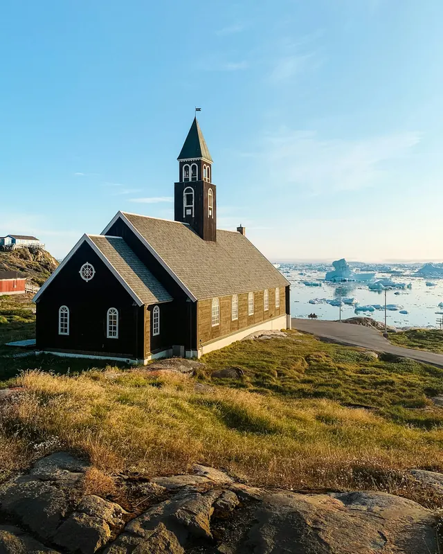 The church at Ilulissat overlooking a bay of icebergs