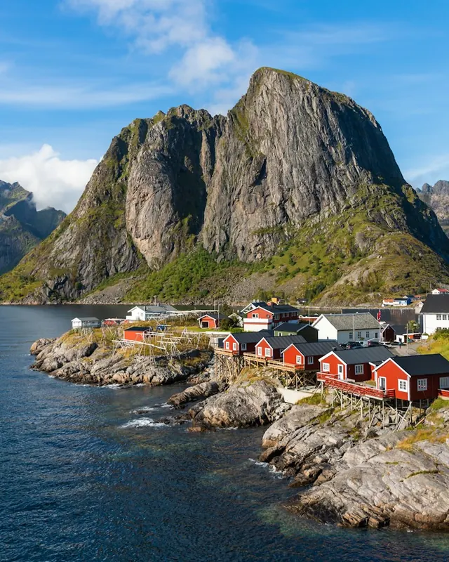 Red fishing cabins below the peaks at Hamnoy in Lofoten