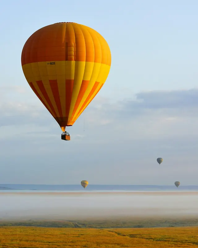 A hot air balloon over the misty Masai Mara
