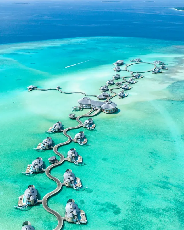 Overwater villas on a turquoise lagoon in the Maldives